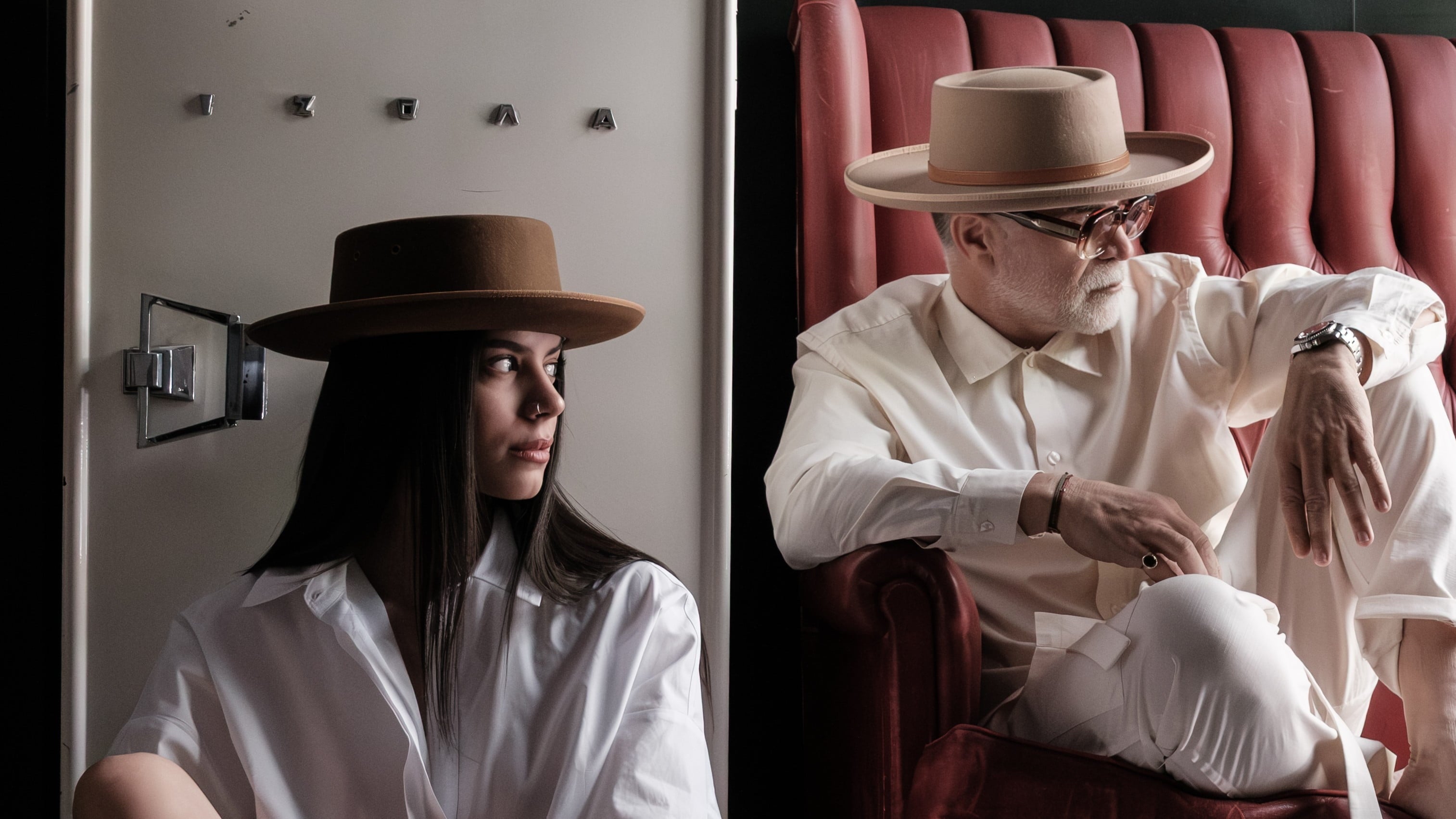 Woman and man wearing handcrafted camel felt wide brim hats — Agnoulita Hats Athens