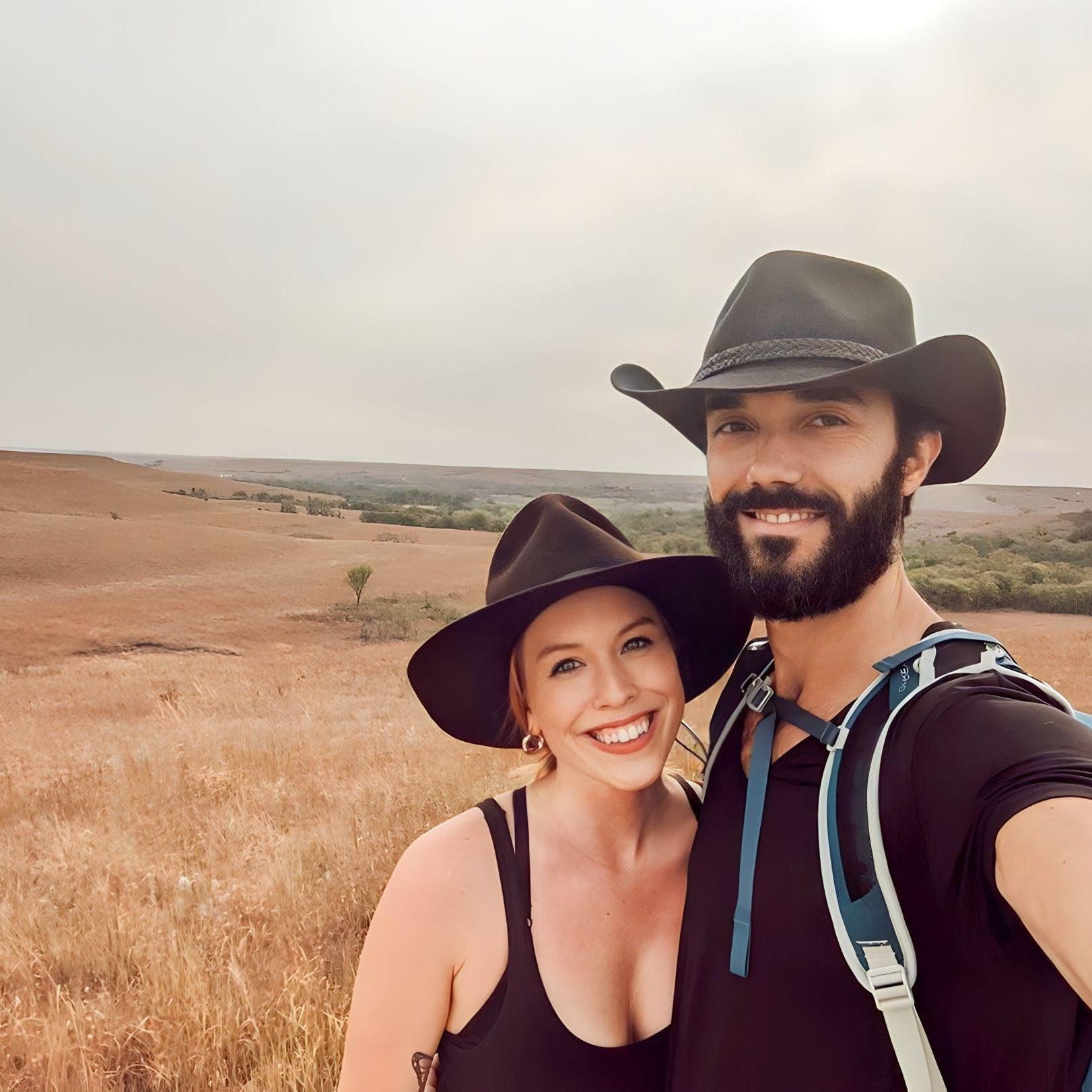 A happy hiking couple stop their way for a selfie photo in their new Agnoulita outdoor hats