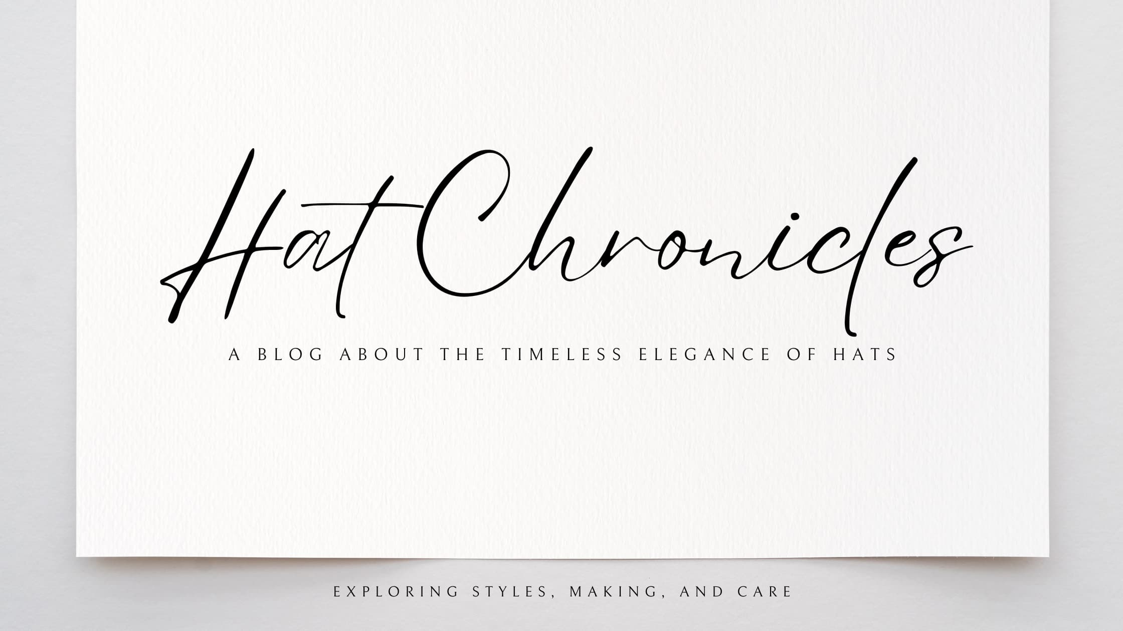 Banner image featuring an elegant piece of luxury paper with a handwritten text that reads 'Hat Chronicles: a blog about the timeless elegance of hats'.