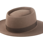 Artisanal wide-brim porkpie hat, named Oppenheimer, in premium beaver felt showcasing the raw edge brim and adorned with a vintage quality ribbon in pecan color against the coffee-hued backdrop of the hat body 4