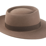 Artisanal wide-brim porkpie hat, named Oppenheimer, in premium beaver felt showcasing the raw edge brim and adorned with a vintage quality ribbon in pecan color against the coffee-hued backdrop of the hat body 5