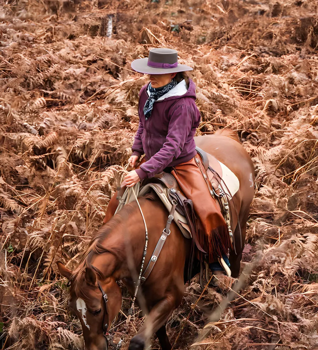 Forest photo of a woman horseback riding donned in an Agnoulita Buckaroo hat