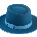 Close-up of Equinox dark teal fedora hat with sky grosgrain ribbon band and bow