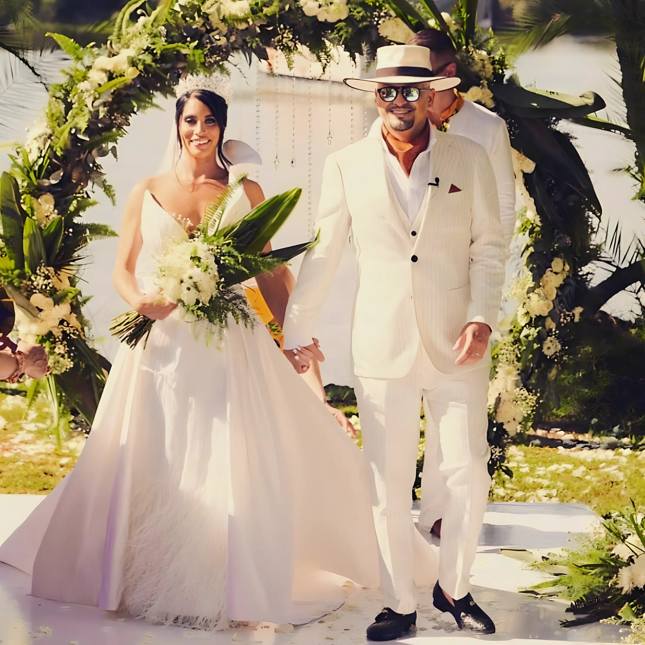 Wedding photo of a bride and groom, with the groom wearing an ivory wide brim Agnoulita hat